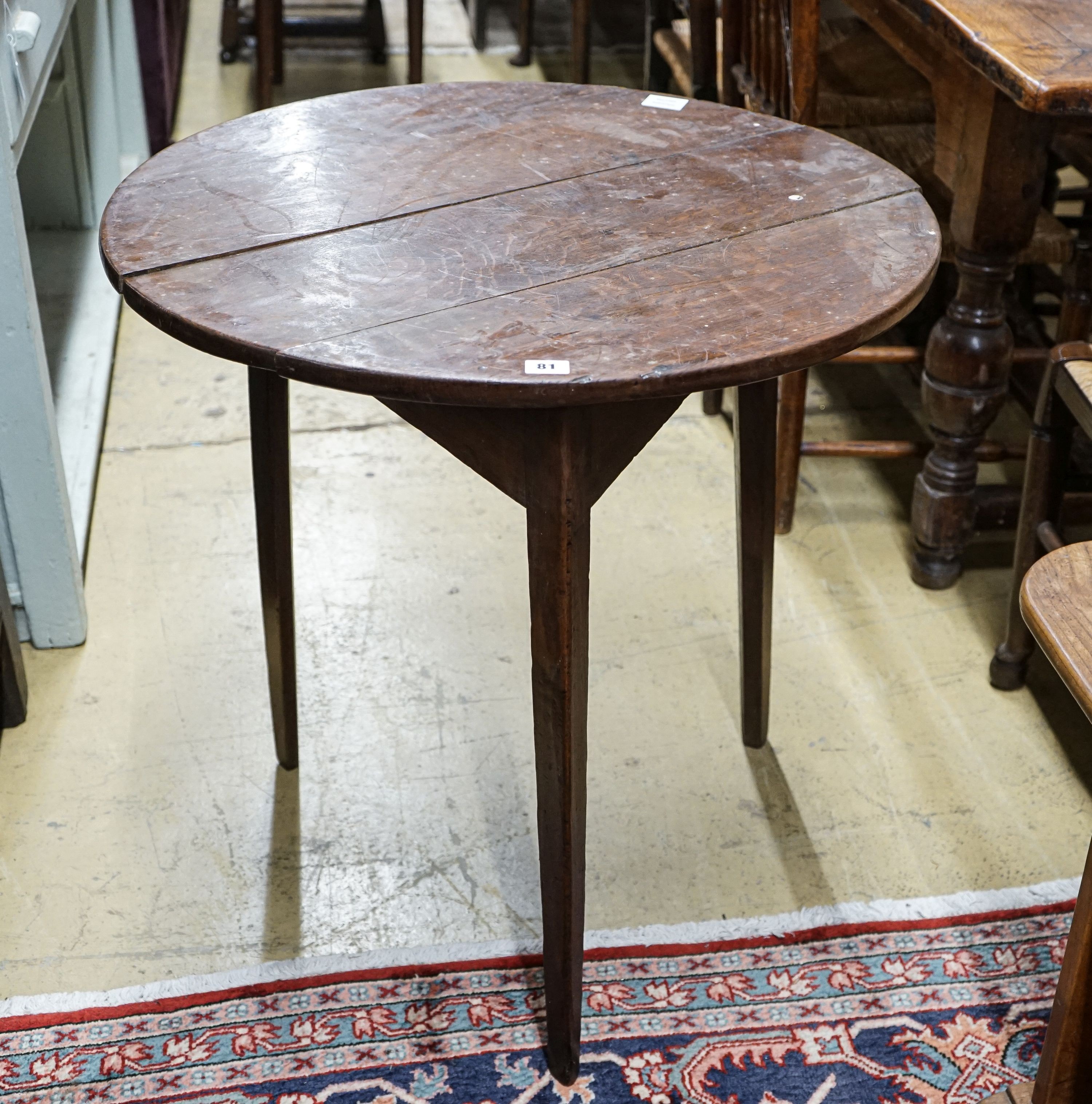 A George III oak cricket table, with circular top on tapered triangular legs, diameter 71cm height 72cm